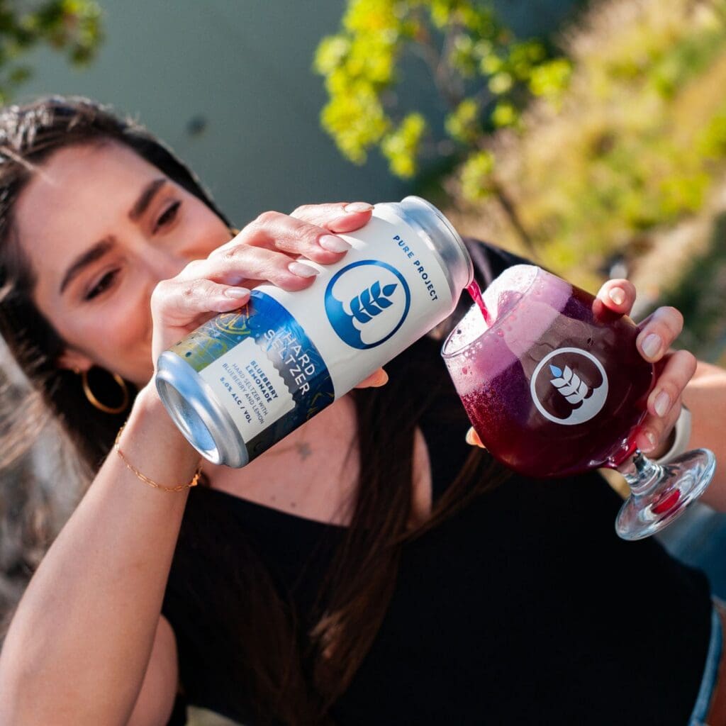 Can and pour of Blueberry Lemonade Hard Seltzer