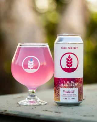 Now available on tap and in cans to-go at all Pure Project taprooms!⁠
⁠
DRAGON FRUIT LEMONADE 🍋🐉⁠
Hard Seltzer with Dragon Fruit & Lemon⁠
Taste Profile: Lemon. Rose Water. Raspberry.⁠
5.0% ABV⁠
⁠
Meet Dragon Fruit Lemonade, our newest hard seltzer infused with 240 pounds of vibrant dragon fruit and 320 pounds of zesty lemon. This light-bodied, spritzy brew bursts with crisp, refreshing flavors and a subtle floral twist. Crafted for warm summer days, it’s the perfect companion for poolside lounging or sunset sipping.⁠
⁠
🔗 Tap the link in our bio to order for taproom pickup or find Pure near you!